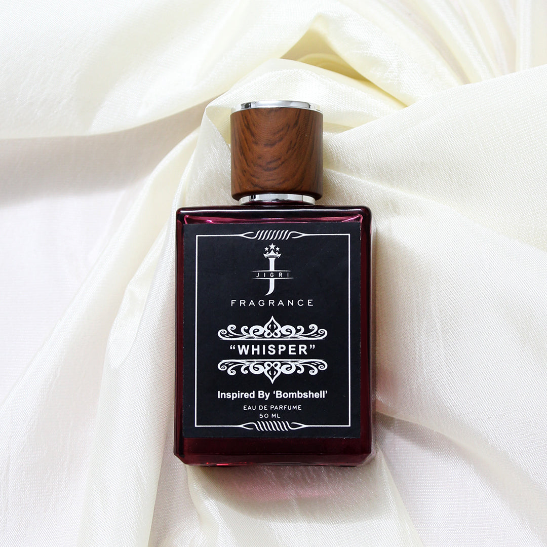WHISPER fragrance for women inspired by Bombshell, showcasing a luxurious bottle against a light fabric background.
