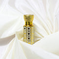 Mehek-e-Noor Attar by Jigri, a luxurious fragrance for men, showcased in an elegant gold and clear bottle.