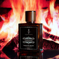 PARAGON fragrance bottle inspired by Baccarat Rouge 540, set against a warm, fiery backdrop, embodying luxury and elegance.